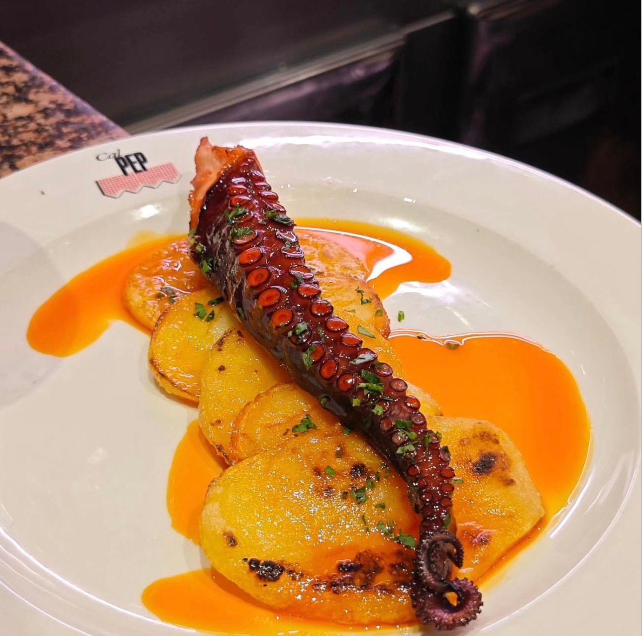 Grilled octopus served with potatoes and paprika-infused olive oil at Cal Pep in Barcelona.