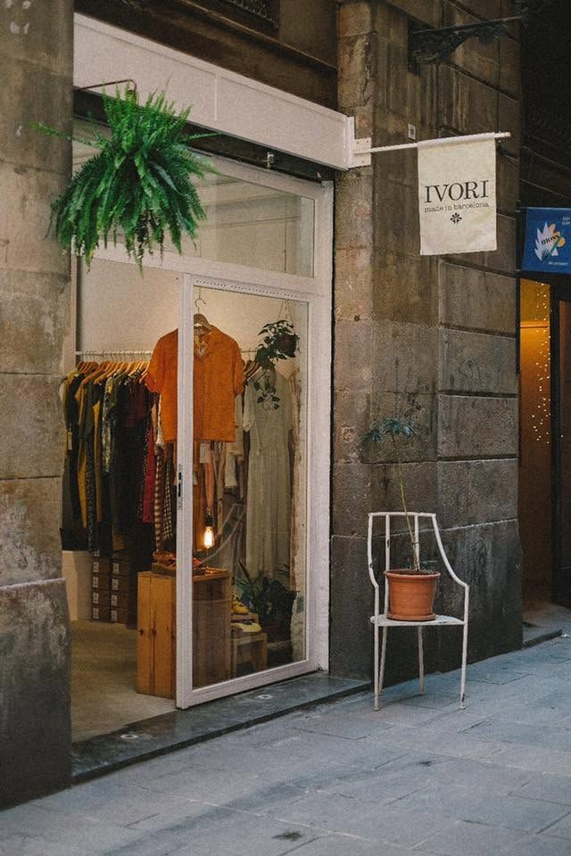 Exterior of Ivori Barcelona boutique with clothing displays visible through the storefront window in the Gothic Quarter.