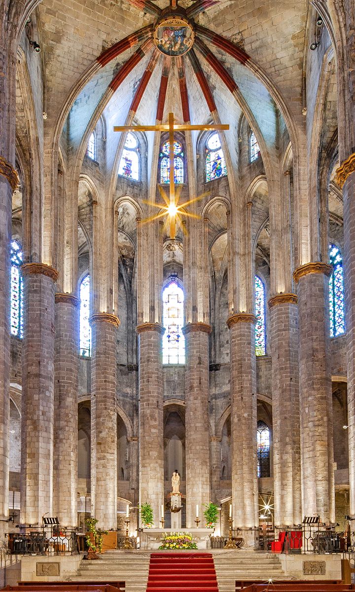 Interior of Santa Maria del Mar Basilica in Barcelona, featuring soaring Gothic columns and stained-glass windows.